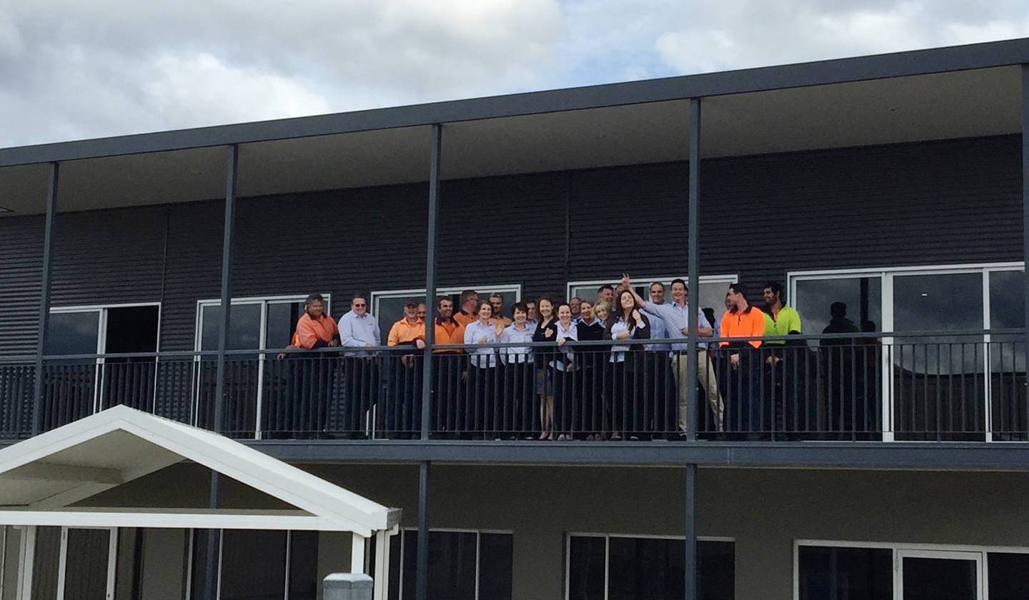The staff at Spantec line up on the balcony at the Spantec office