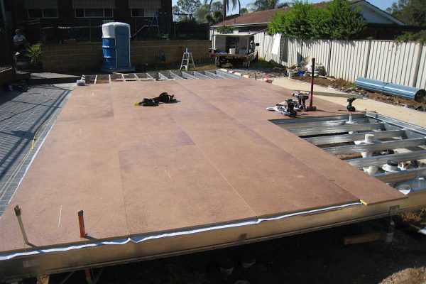 Particle board floor sheeting installation on a Boxspan floor frame