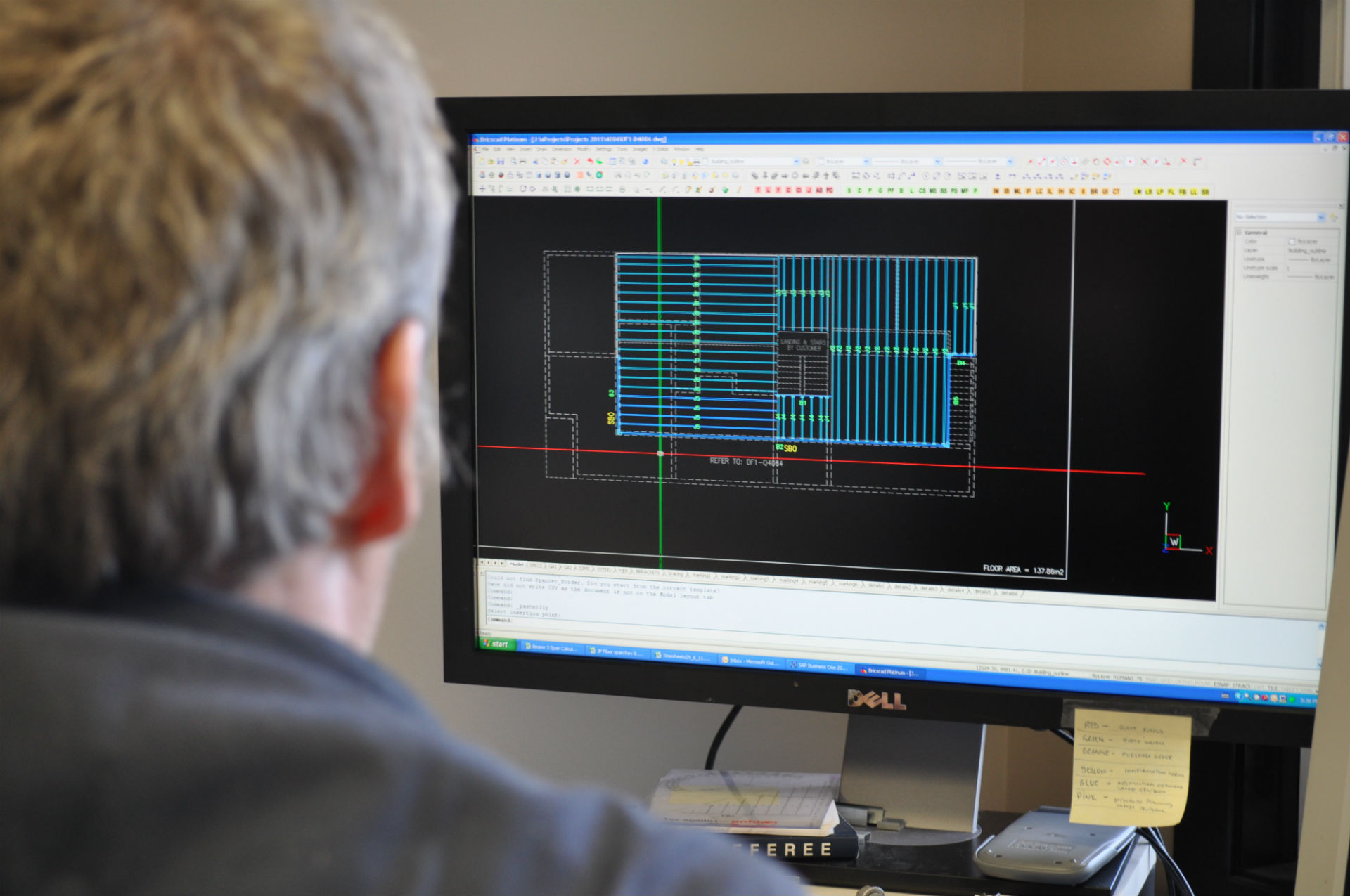 A draftsman uses AutoCAD computer aided drafting software to design a floor frame for a customer.
