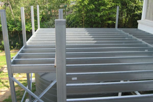 Boxspan steel deck frame over rainwater tank with posts to handrail height
